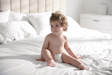 Photo of Cute little baby on bed at home