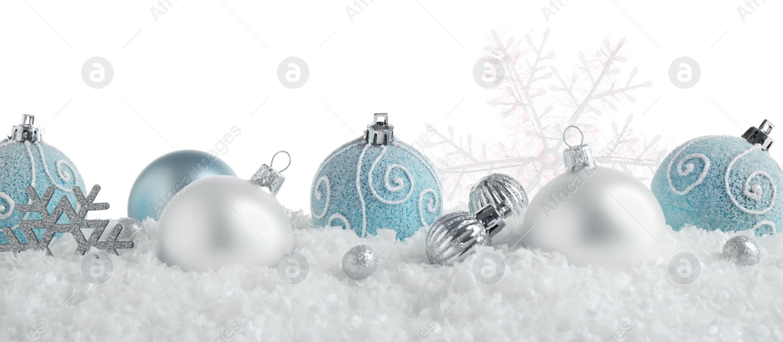 Photo of Christmas tree decoration on artificial snow against white background