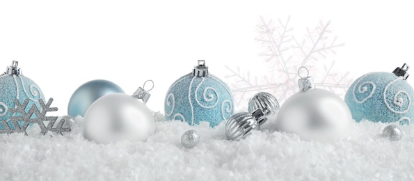 Photo of Christmas tree decoration on artificial snow against white background