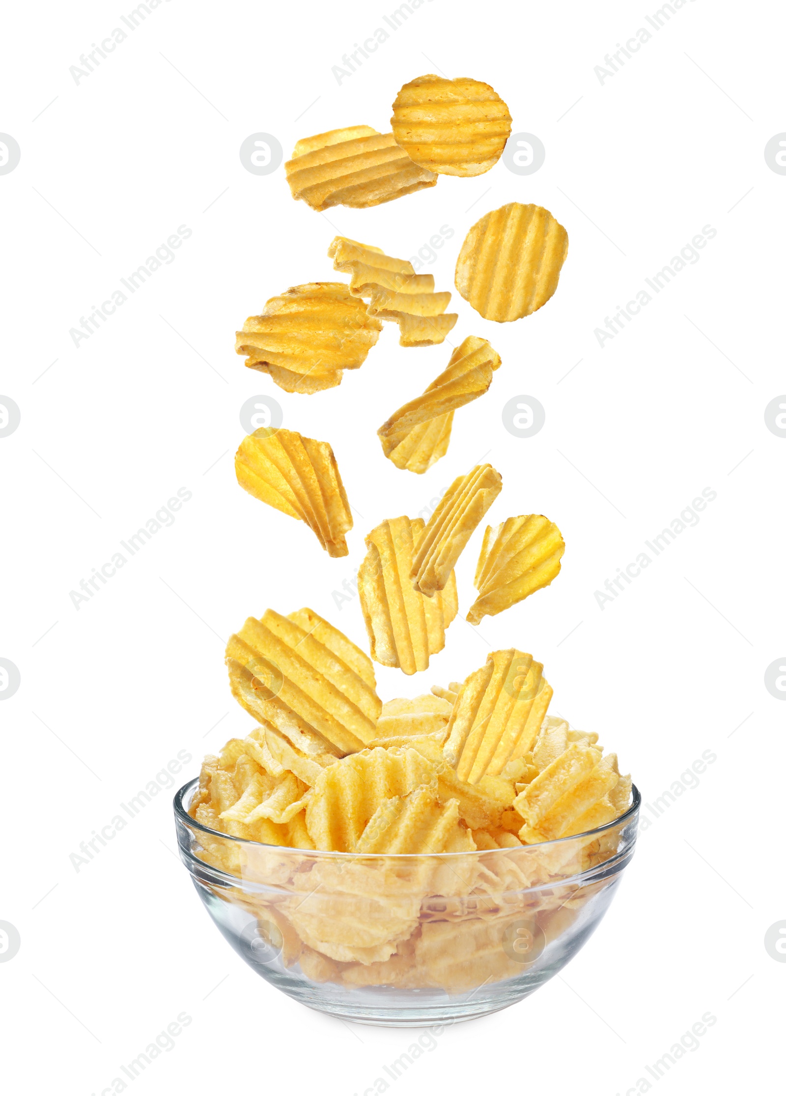 Image of Ridged crispy potato chips falling into bowl on white background