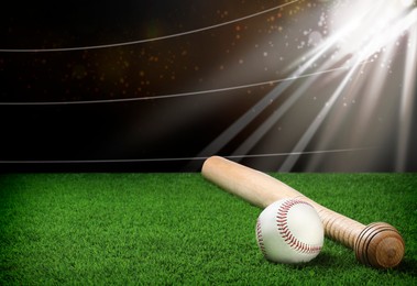 Image of Baseball bat and ball on grass at stadium. Space for text