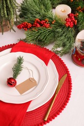 Luxury place setting with beautiful festive decor for Christmas dinner on white table