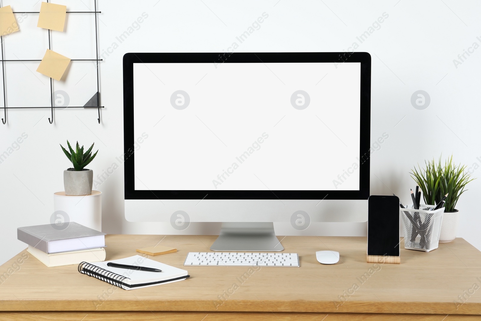 Photo of Cozy workspace with computer and stationery on wooden desk at home