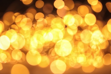 Gold glitter with bokeh effect on dark background