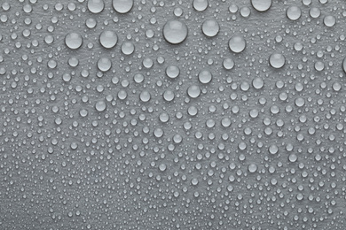 Photo of Water drops on grey background, top view