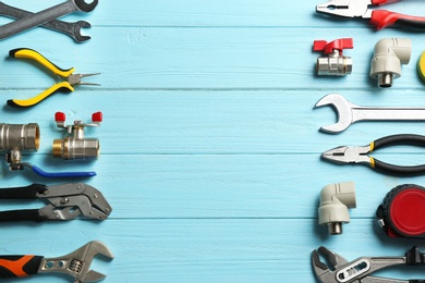 Photo of Flat lay composition with plumber's tools and space for text on blue wooden background