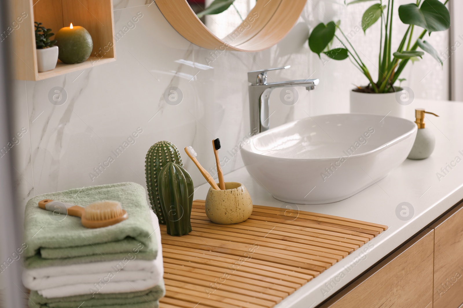 Photo of Stylish vessel sink on light countertop in modern bathroom