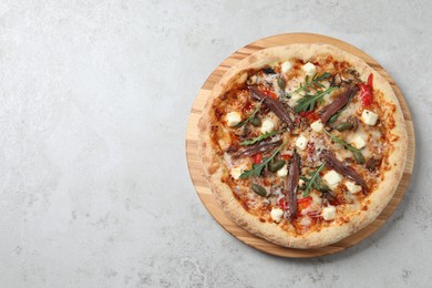 Tasty pizza with anchovies, arugula and olives on grey table, top view. Space for text