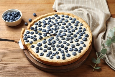 Photo of Tasty cake with blueberry on wooden table