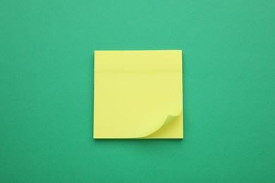 Empty notes on green background, top view. Space for text