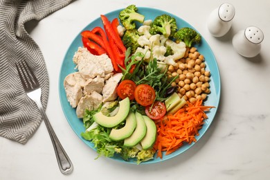 Balanced diet and healthy foods. Plate with different delicious products on white marble table, top view