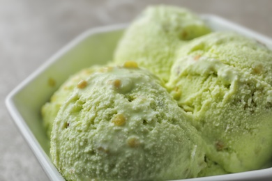 Delicious pistachio ice cream in bowl, closeup