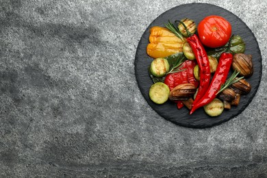 Photo of Delicious grilled vegetables on grey table, top view. Space for text