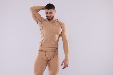 Photo of Man in warm thermal underwear on light background. Space for text