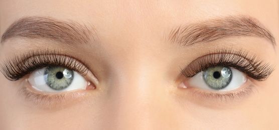 Image of Young woman with beautiful long eyelashes, closeup view. Banner design