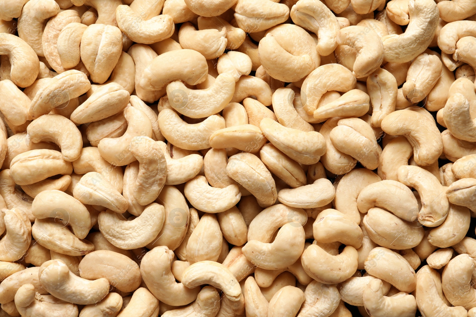 Photo of Tasty cashew nuts as background, top view