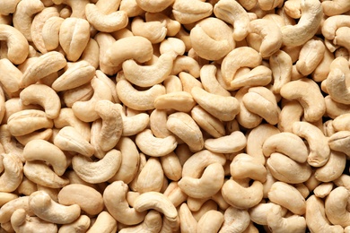 Tasty cashew nuts as background, top view