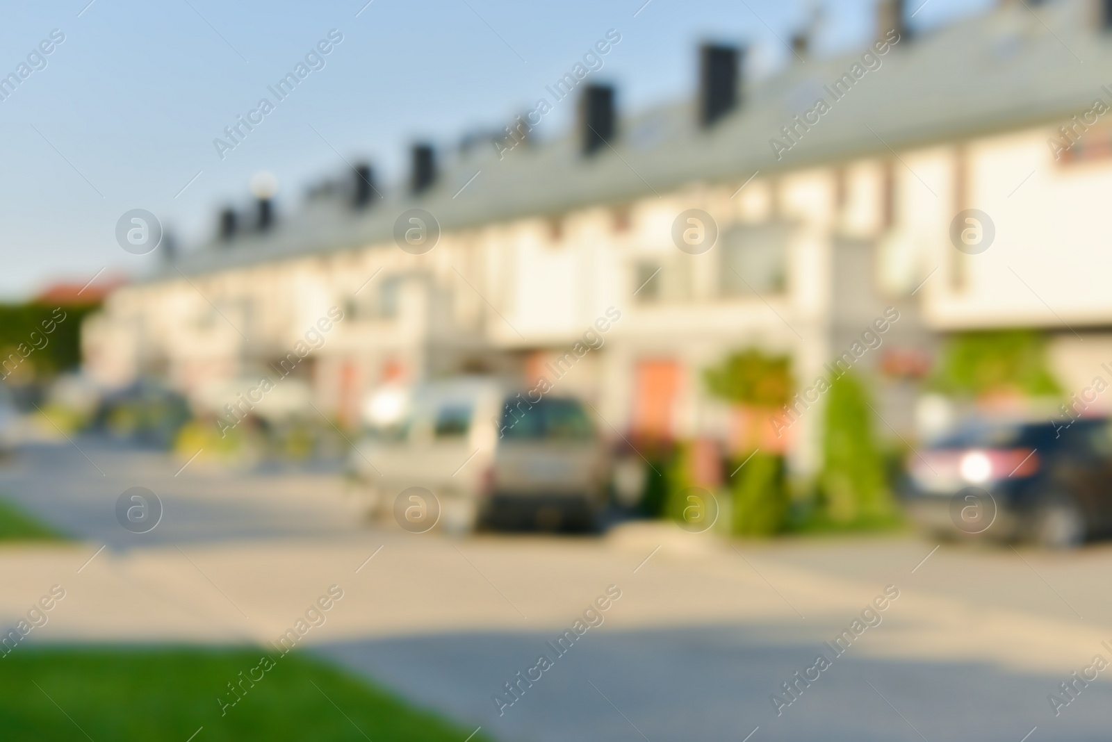 Photo of Blurred view of suburban street with beautiful houses