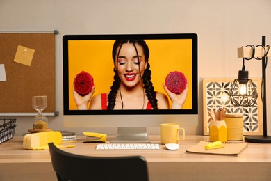 Stylish workplace with computer on wooden desk near light wall. Interior design