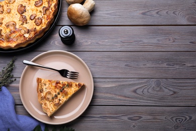 Delicious pie with mushrooms and cheese served on wooden table, flat lay