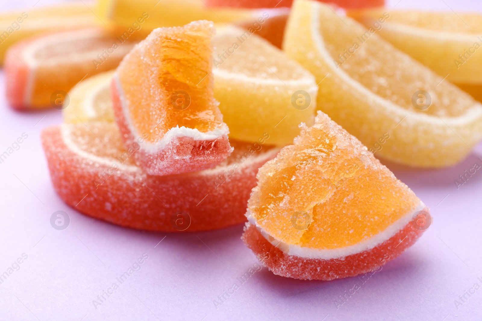 Photo of Tasty bright jelly candies on color background