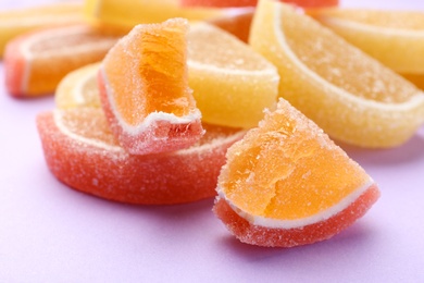 Tasty bright jelly candies on color background