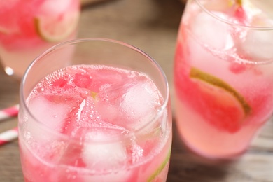 Photo of Delicious refreshing watermelon drink on wooden table, closeup
