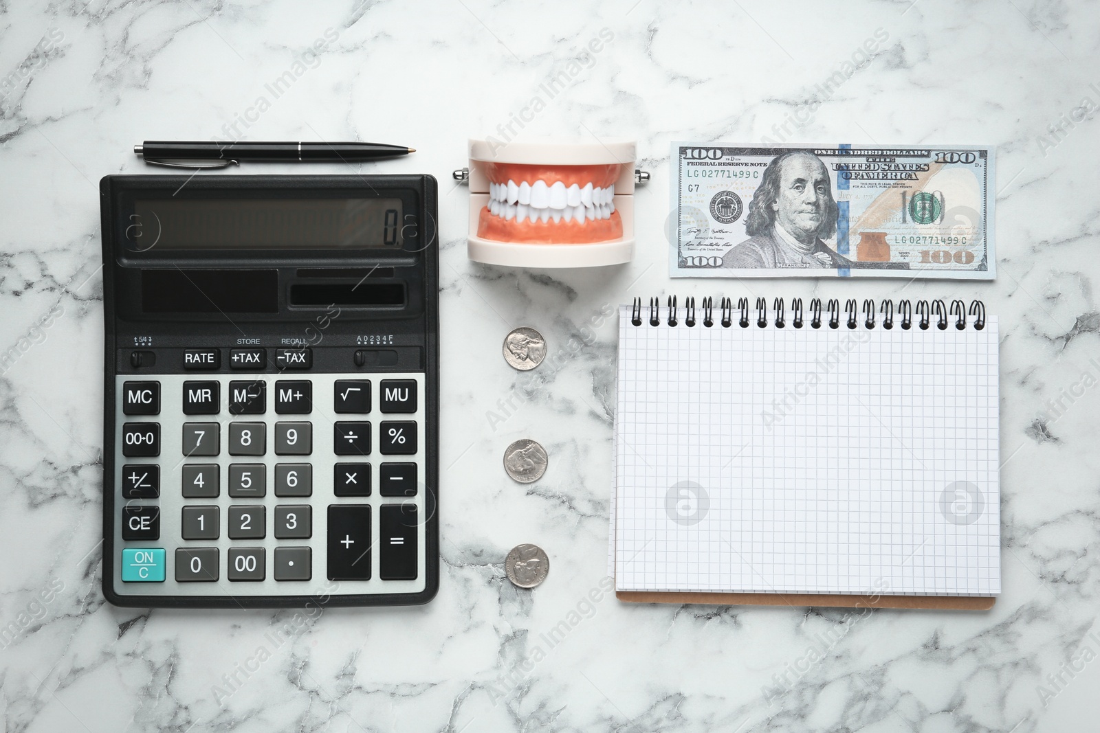 Photo of Flat lay composition with educational dental typodont model and money on white marble table. Expensive treatment