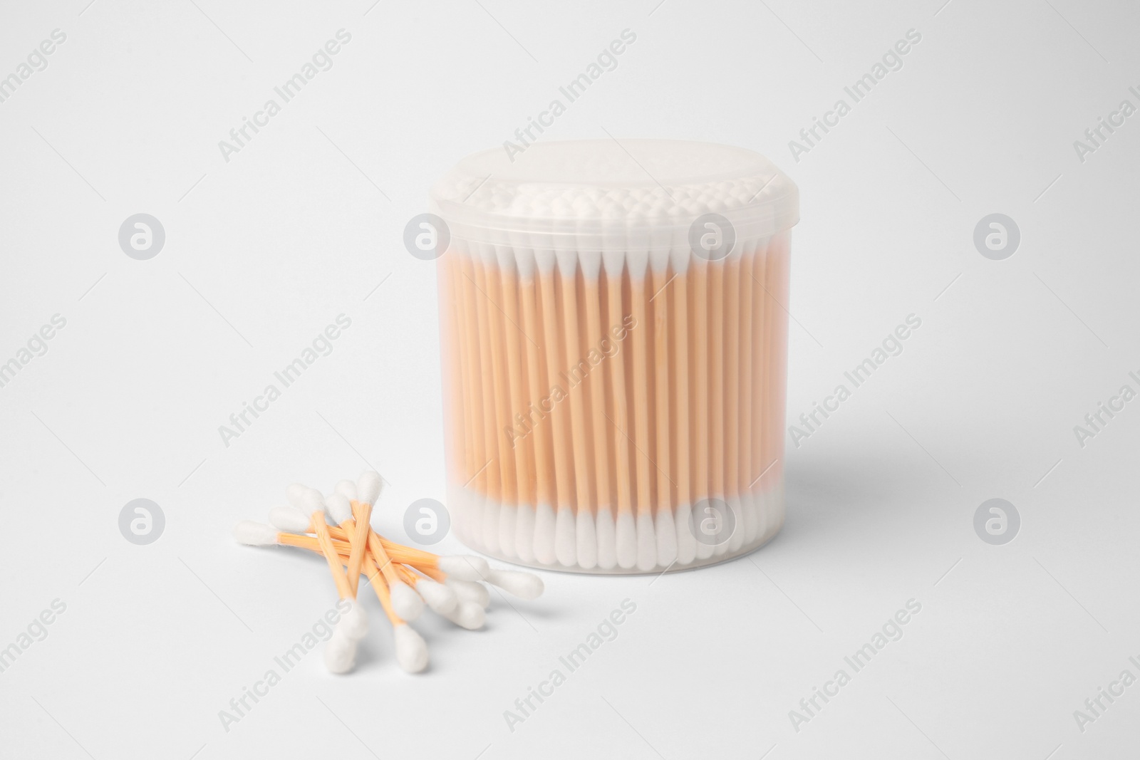 Photo of Cotton buds in plastic container isolated on white