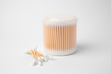 Cotton buds in plastic container isolated on white