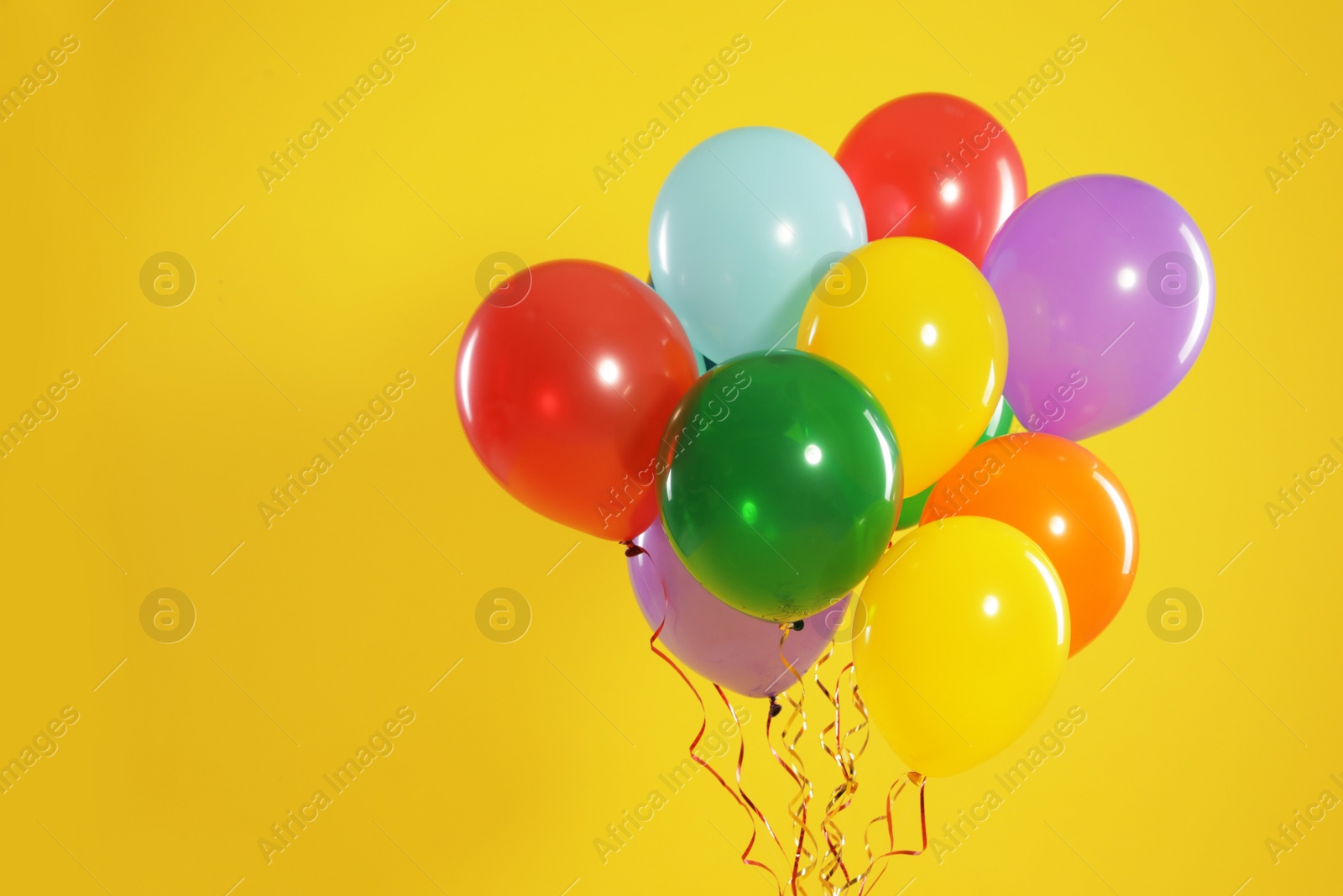 Photo of Bunch of bright balloons on color background, space for text. Celebration time