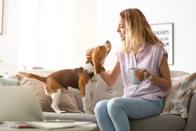 Young woman with her dog at home