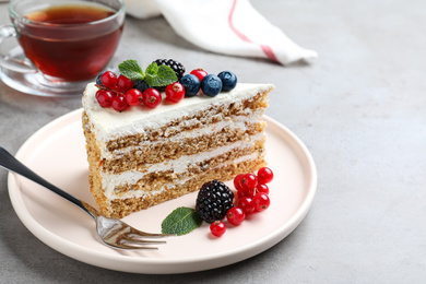 Tasty cake with berries on grey table