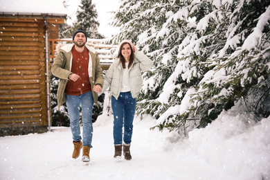 Photo of Lovely couple spending time together on snowy day. Winter vacation