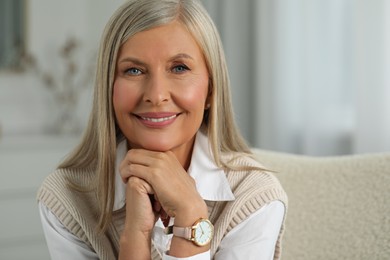 Photo of Portrait of beautiful middle aged woman at home, space for text