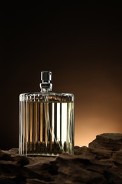 Luxury men`s perfume in bottle against brown background