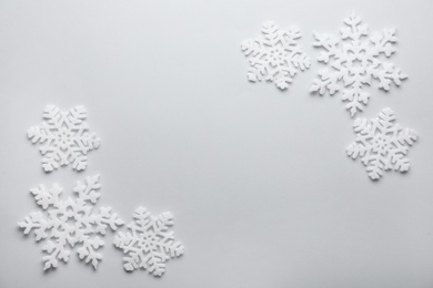 Beautiful snowflakes on white background, flat lay. Space for text