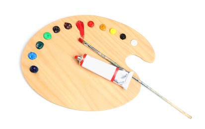 Photo of Palette with acrylic paints and brush on white background, top view. Artist equipment