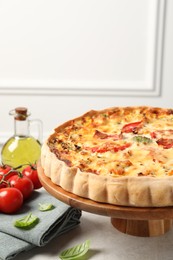 Photo of Tasty quiche and products served on light table, space for text