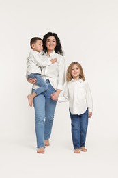 Little children with their mother on white background