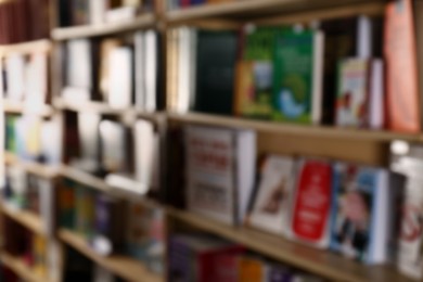 Blurred view of different books on shelves in library