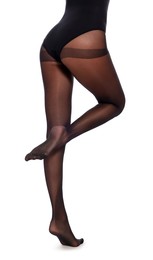 Woman wearing black tights on white background, closeup