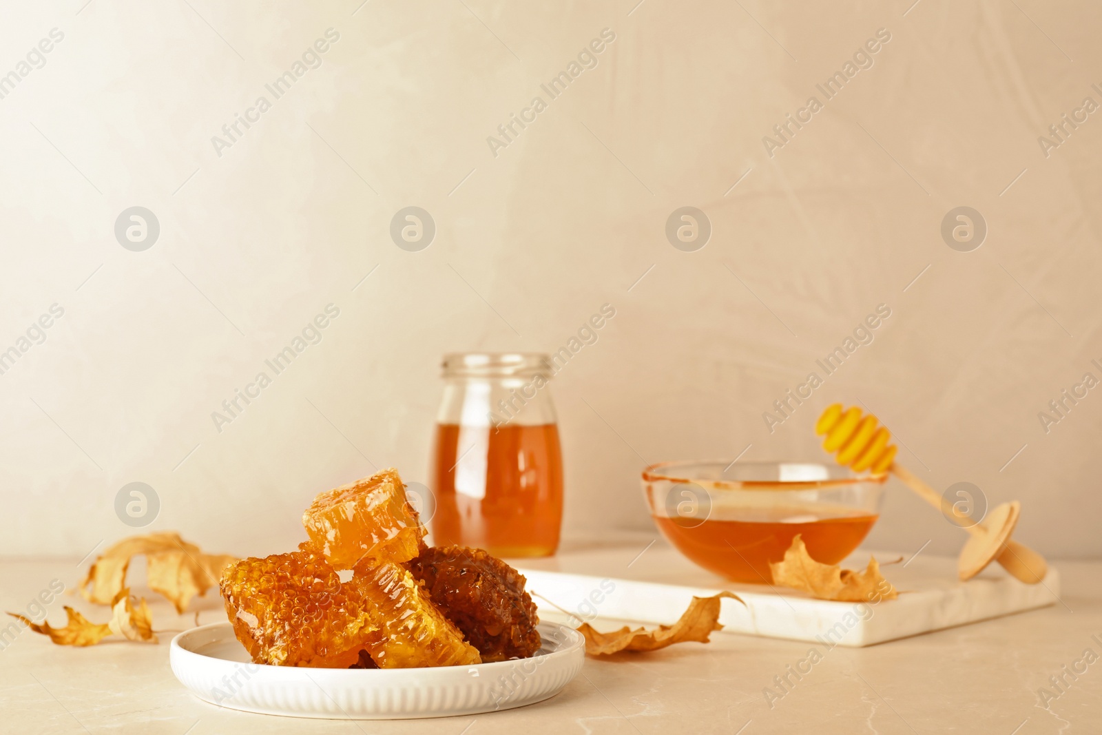 Photo of Composition with tasty honey and combs on table