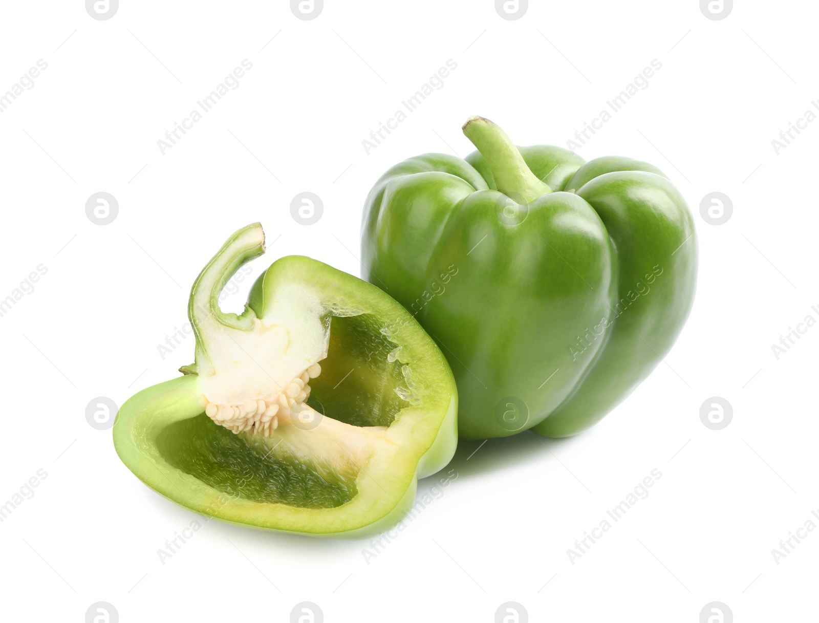 Photo of Cut and whole fresh green bell peppers isolated on white