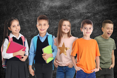 Group of cute school children and chalkboard on background