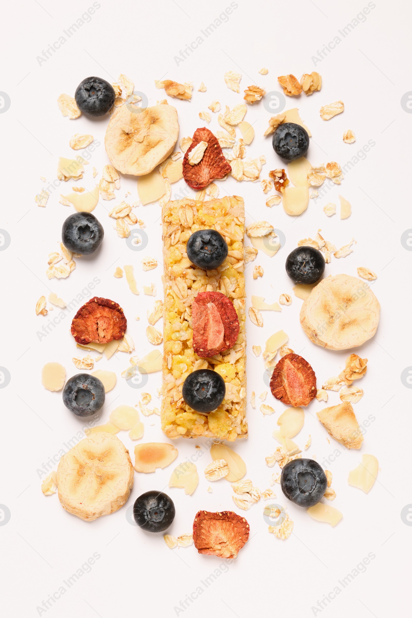 Photo of Tasty granola bar and ingredients isolated on white, top view