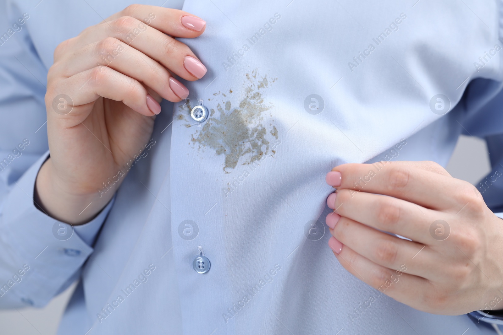 Photo of Woman showing stain on her shirt, closeup