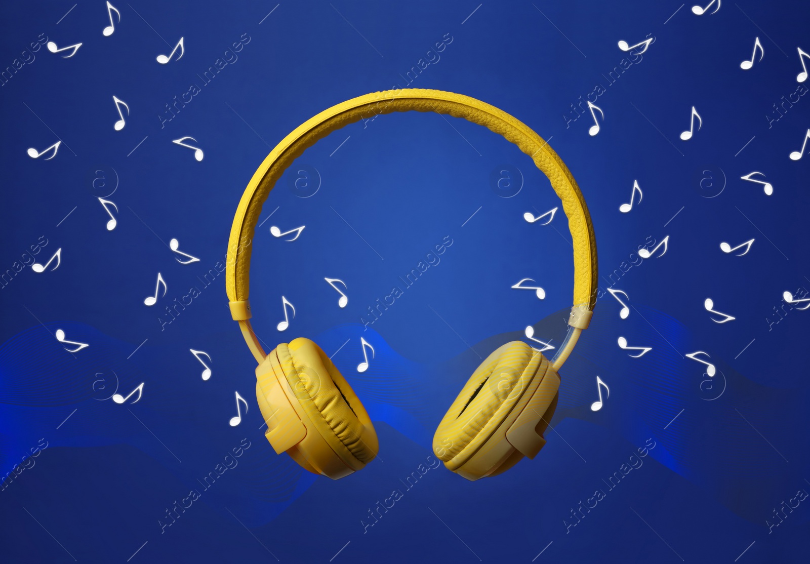 Image of Yellow headphones and flying music notes on blue background