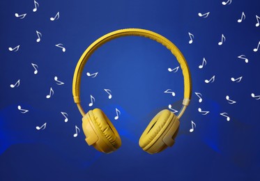 Image of Yellow headphones and flying music notes on blue background