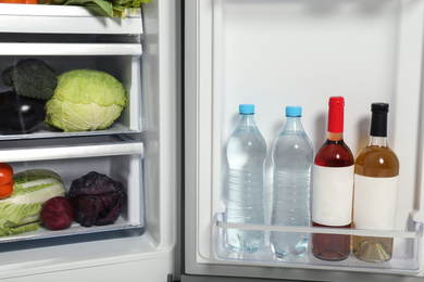 Open refrigerator full of different fresh products